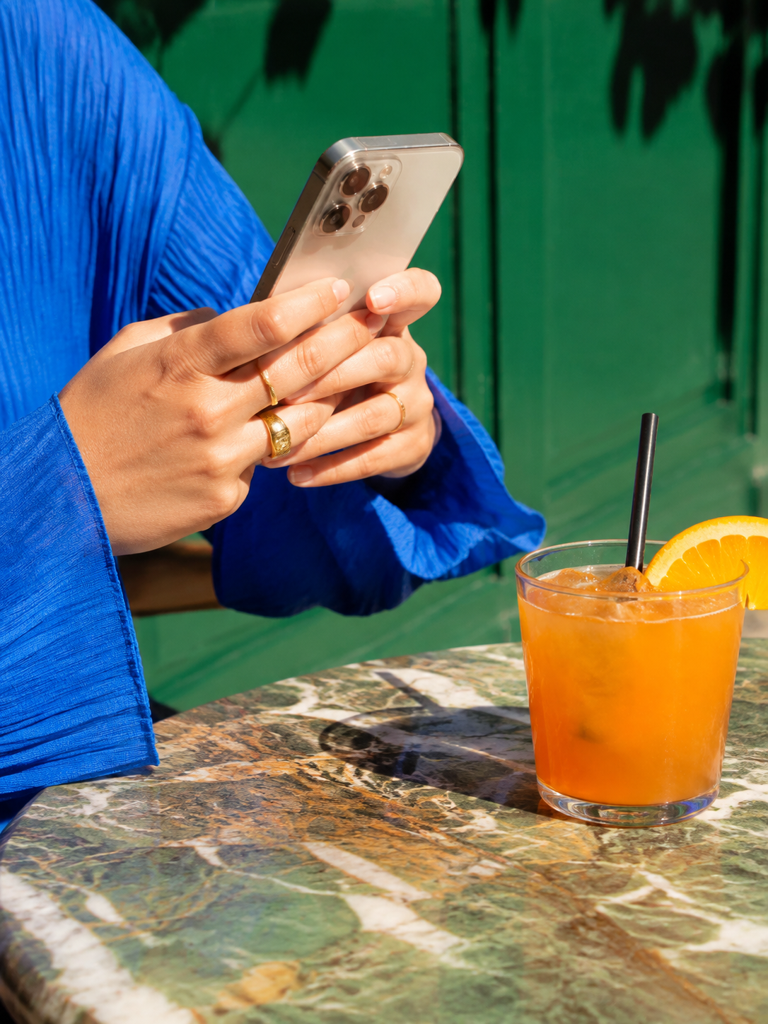 Content creator filming a colourful drink at a café